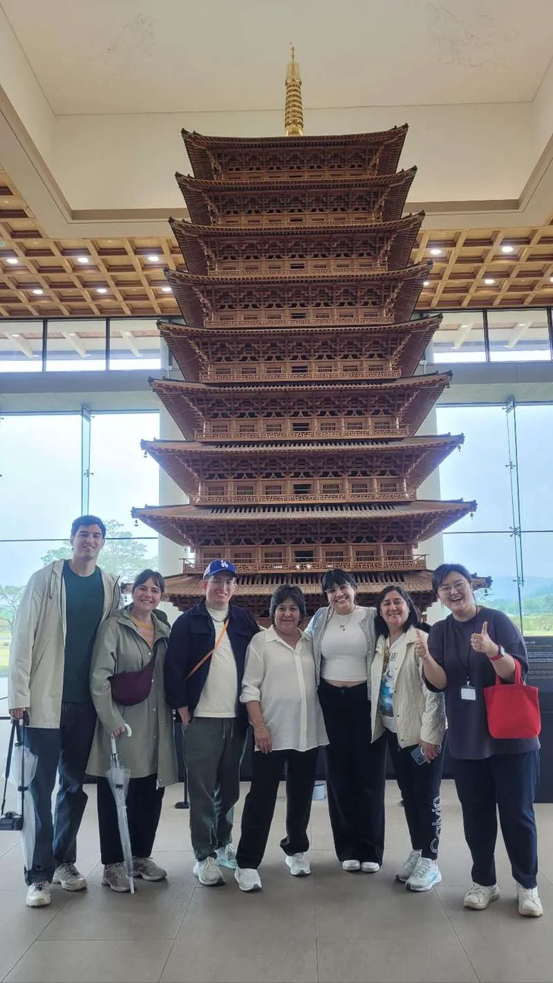 Official city docent leading a small heritage walking tour past a Silla-era monument on a gyeongju city tour in Gyeongju, South Korea